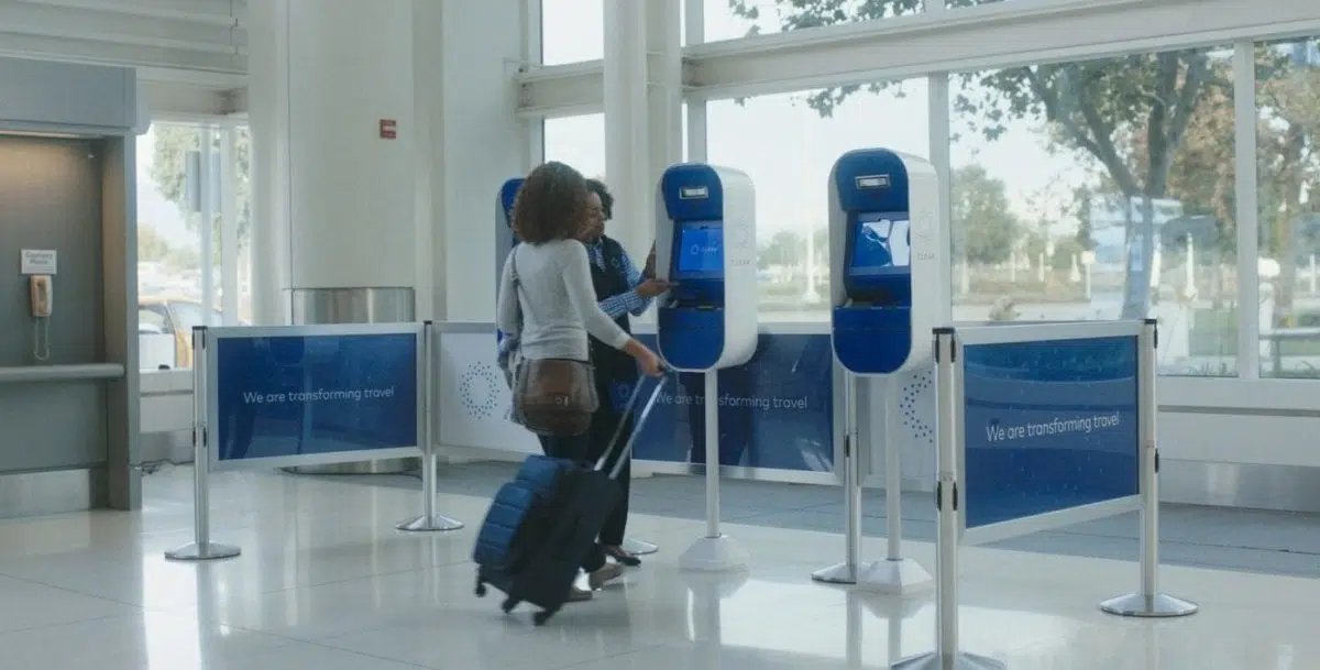 a person at CLEAR kiosks with a representative