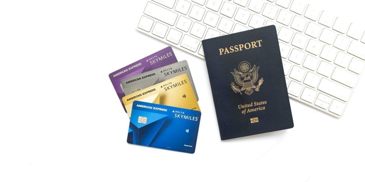 American Express Delta SkyMiles Credit cards with U.S. passport and Apple keyboard