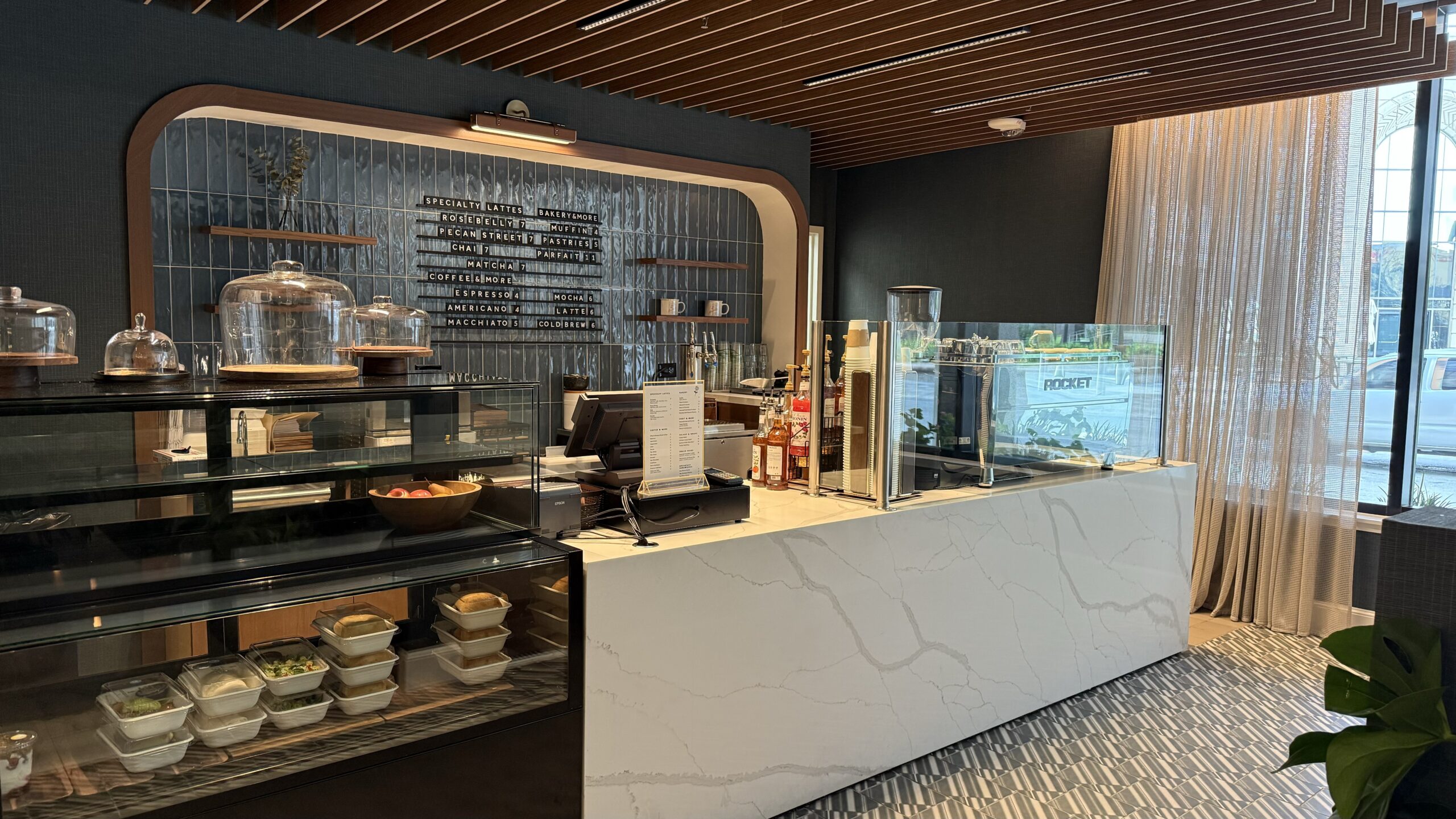 coffee shop counter with food and pastries in a case