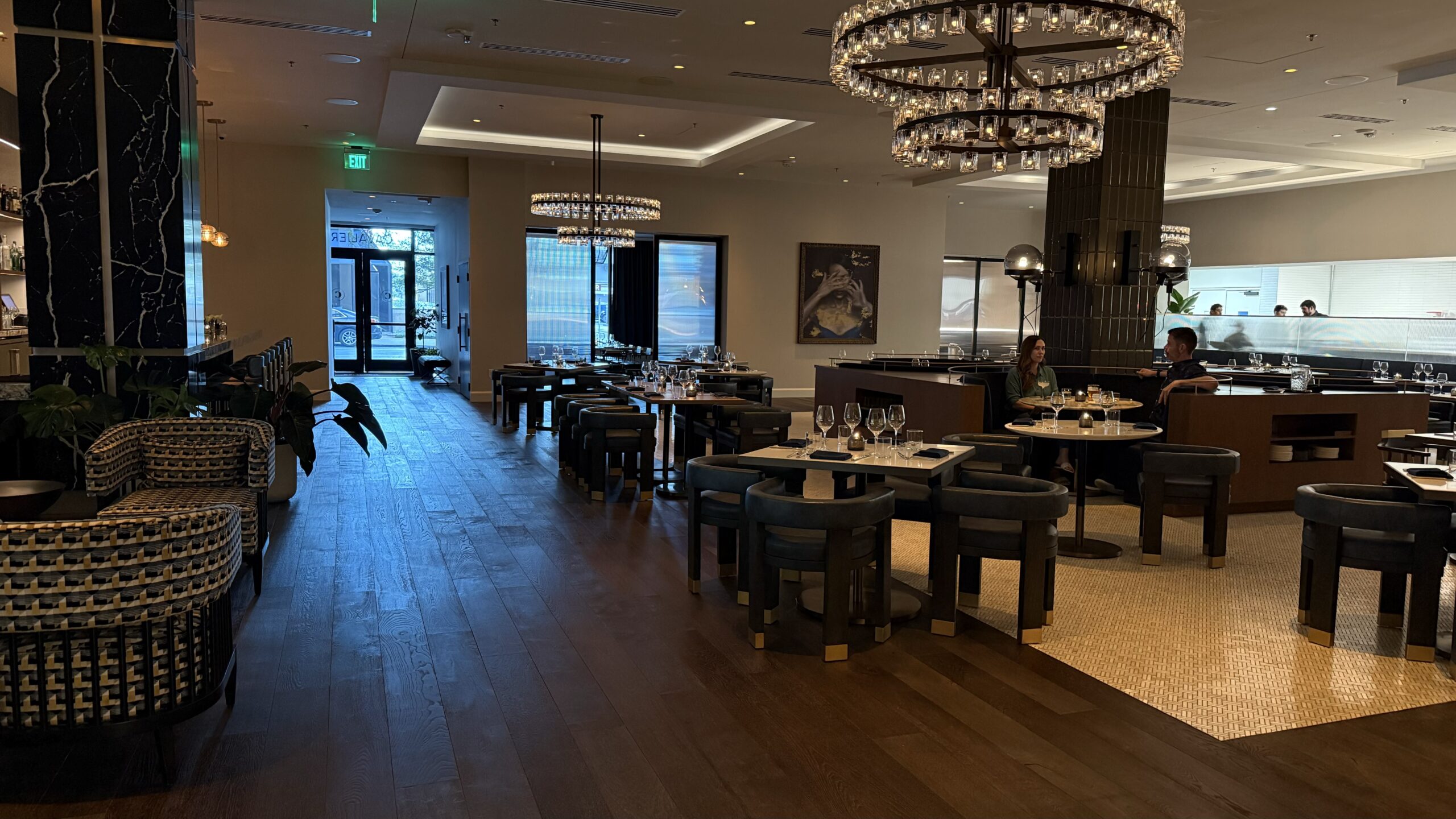 dining room with tables, chairs and a chandelier 