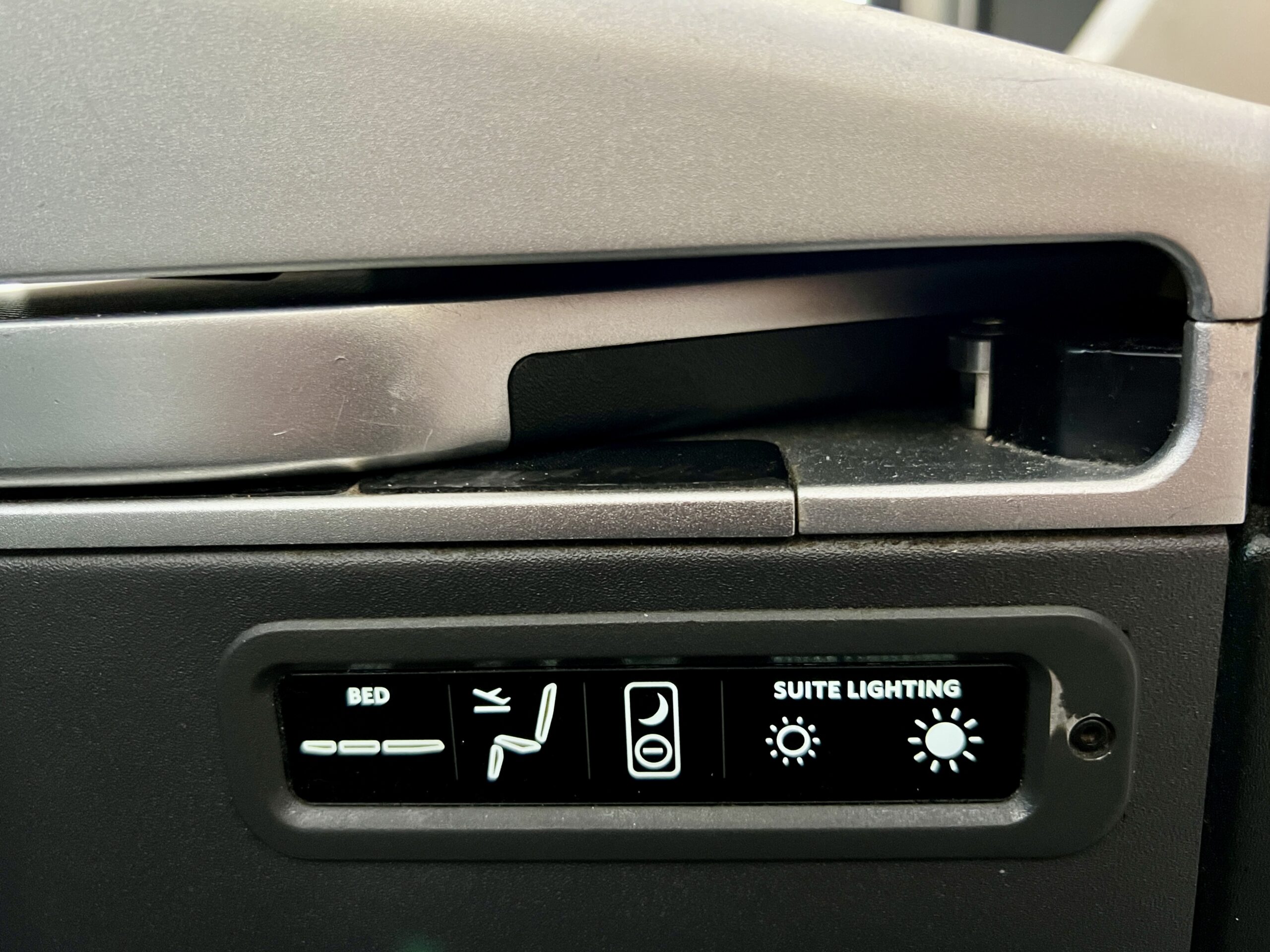 a small panel with seat controls in a plane