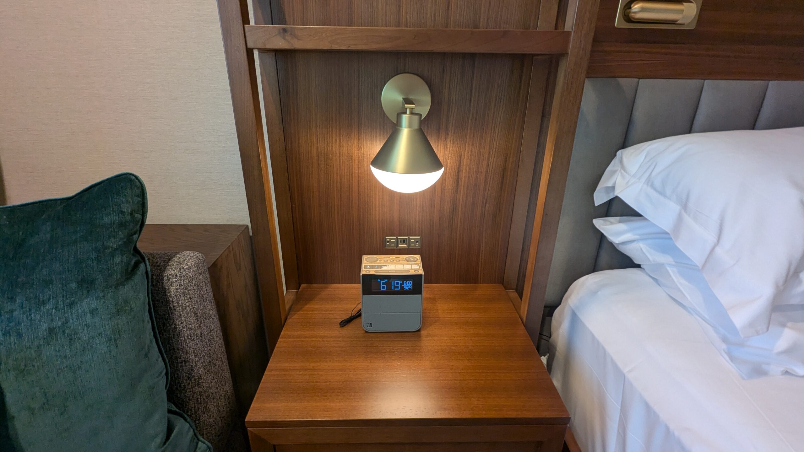 nightstand with reading lamp and alarm clock