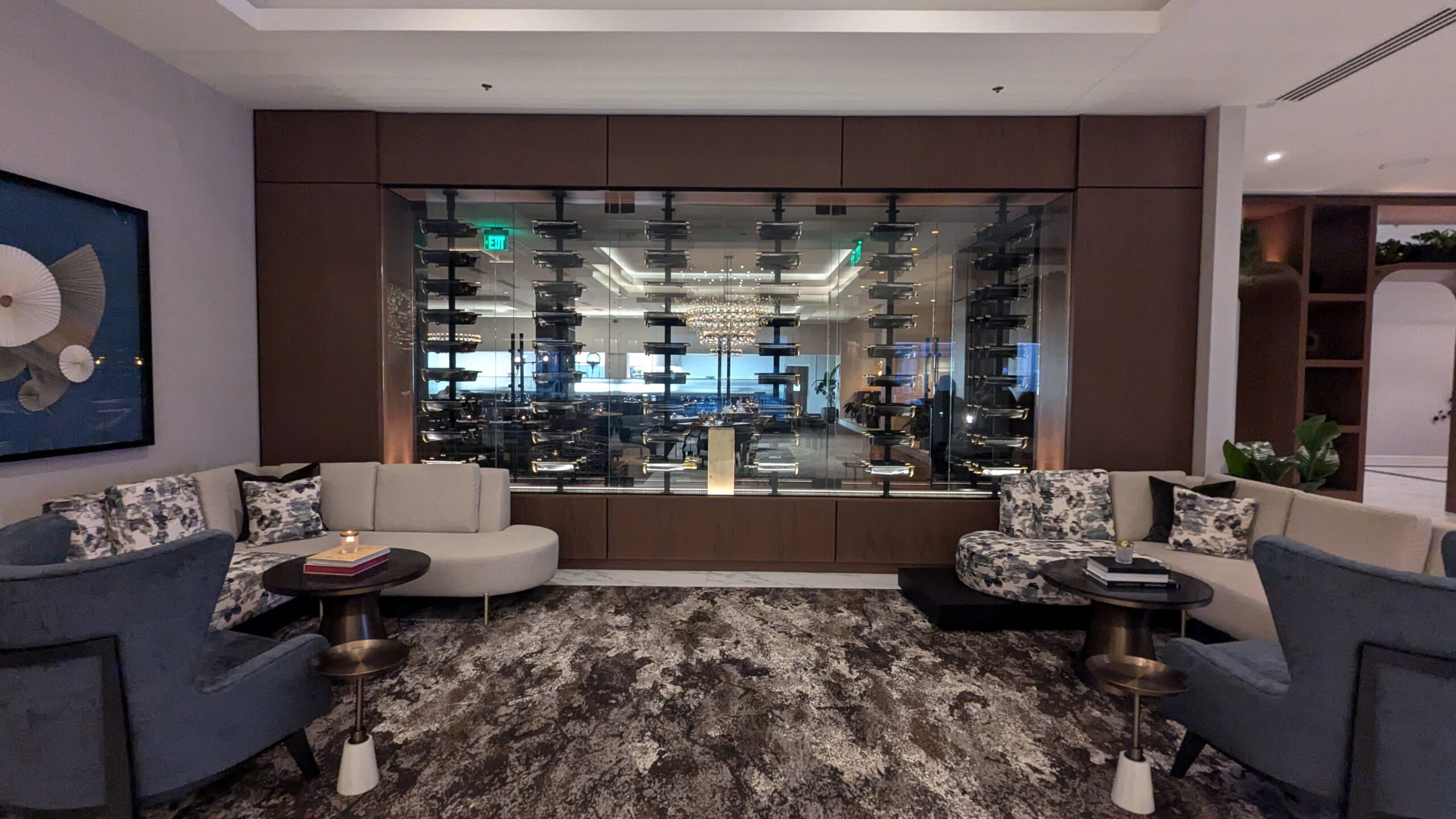 Lobby seating and glass wall with wine bottles