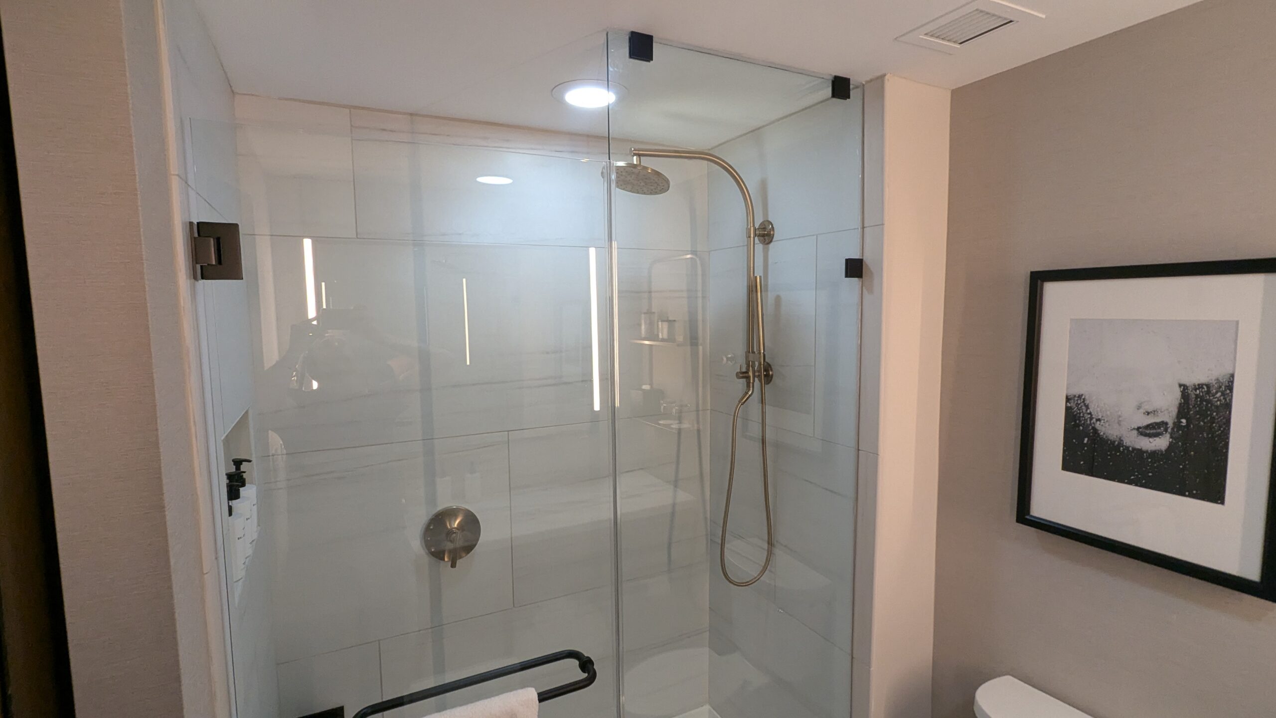 Shower with glass door in a bathroom.