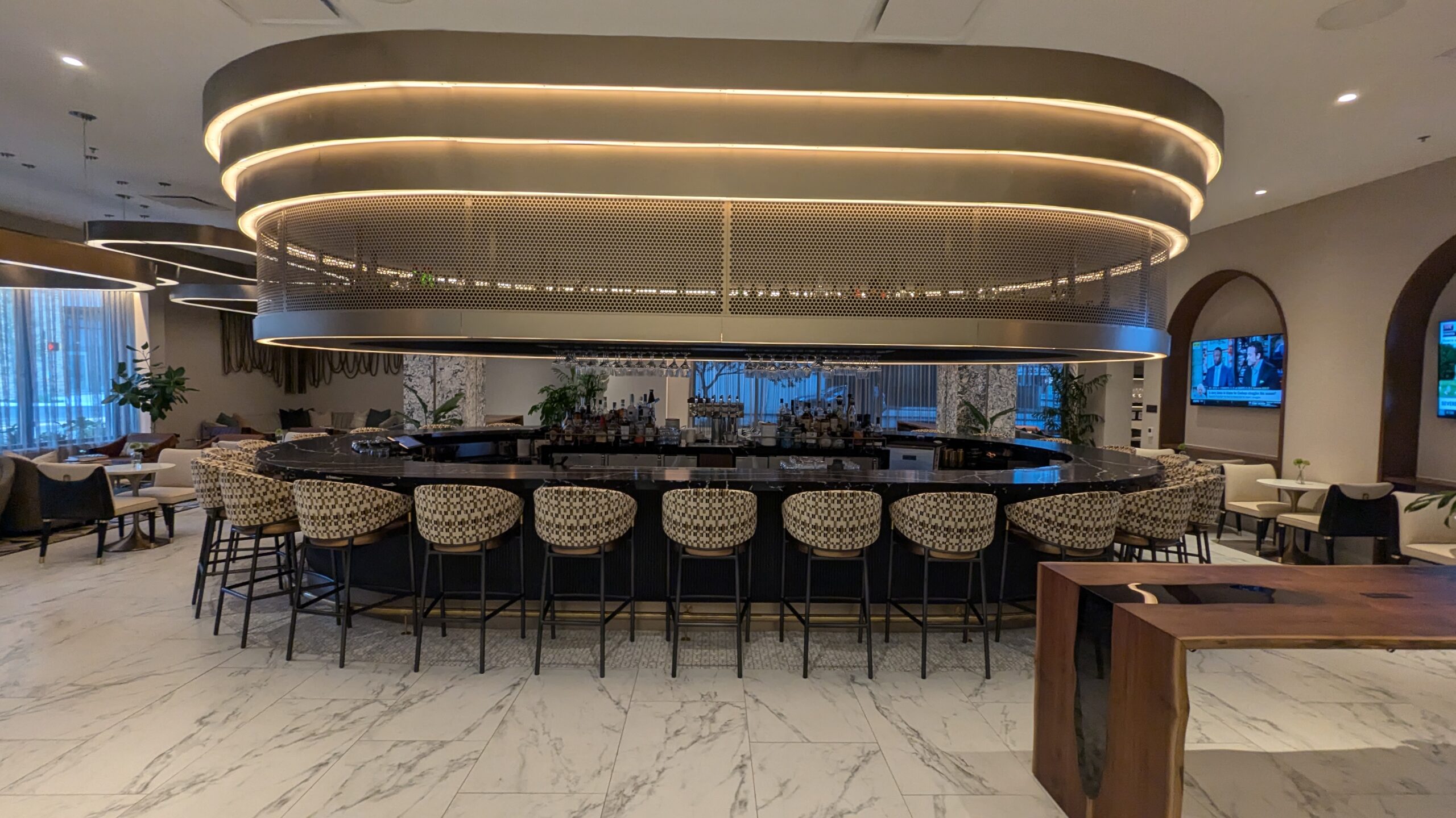 circular bar with bar stools and large oval light fixture