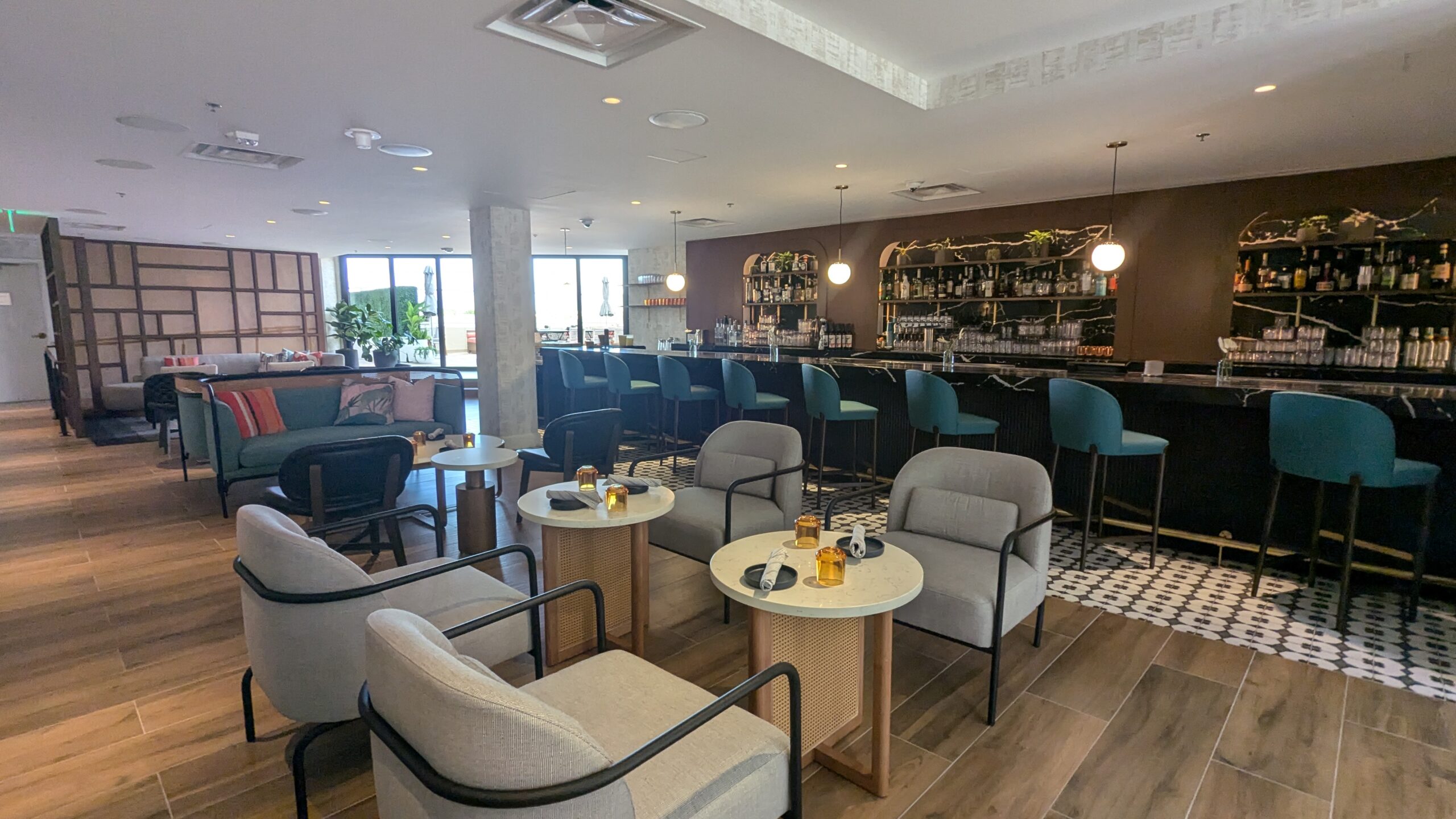 tables and chairs inside a bar