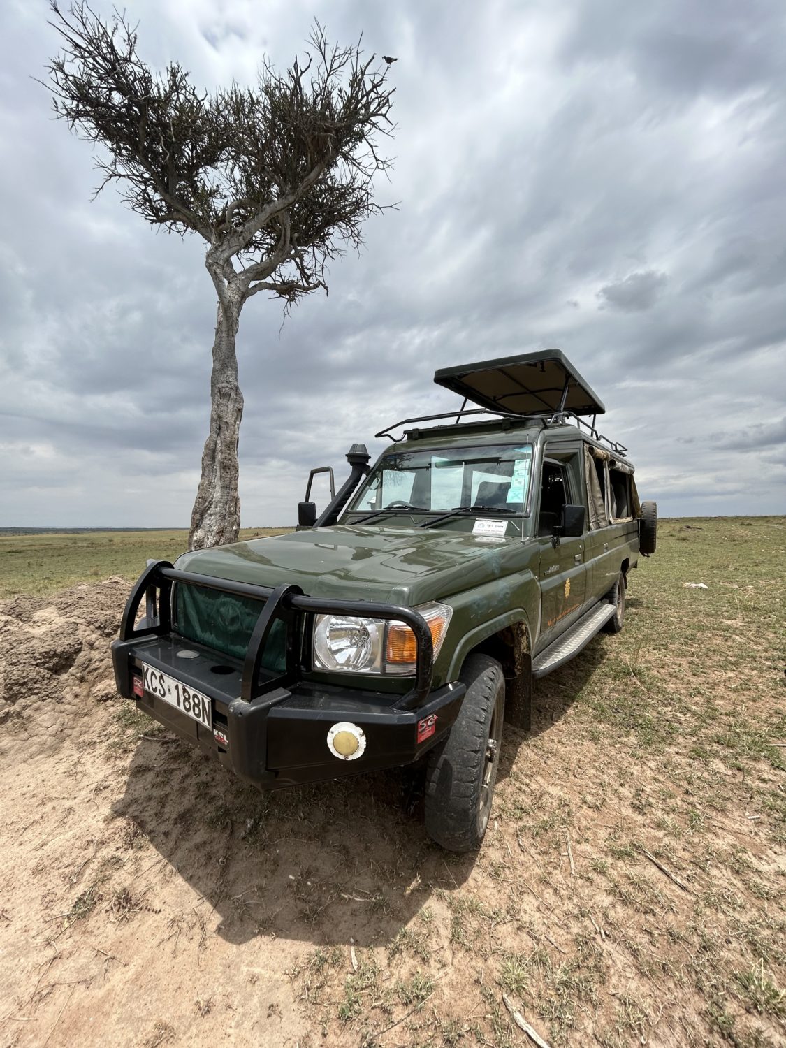 A car parked in a dirt field