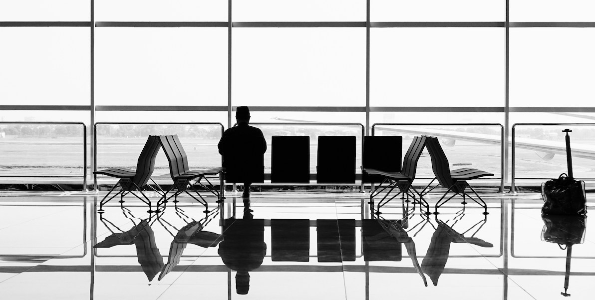 person waiting by their gate at the airport