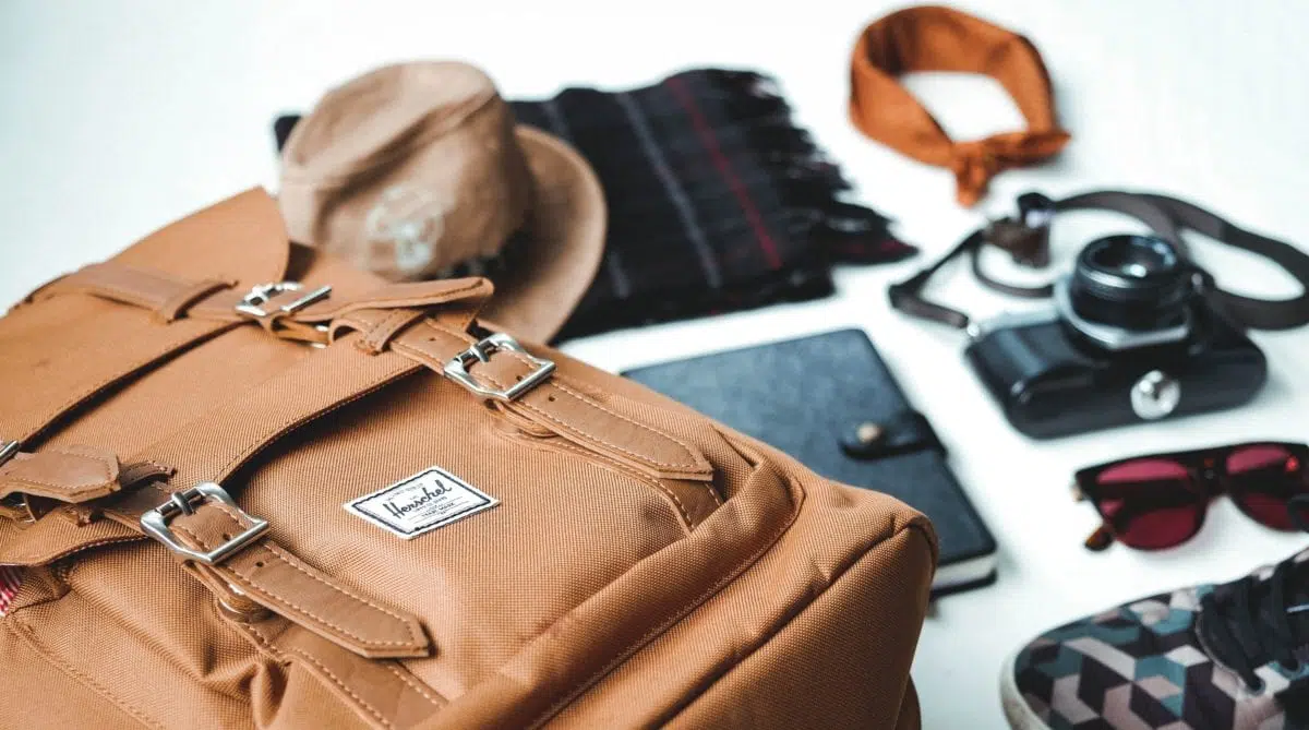 a backpack with items on a table